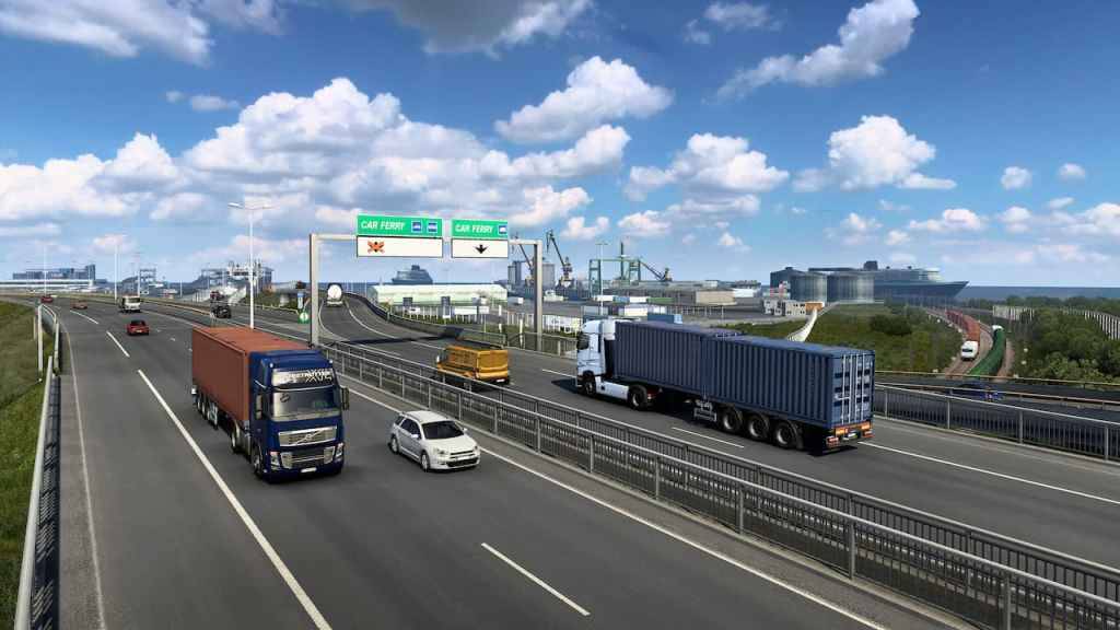 Camiones y automóviles que conducen a lo largo de una carretera.